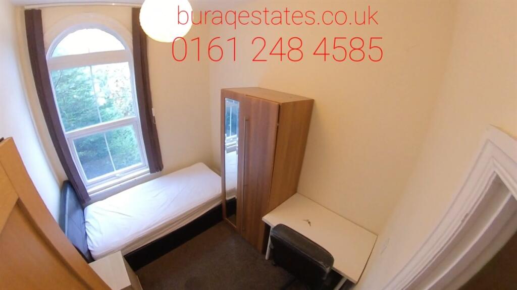 A cozy single bedroom featuring a comfortable s...