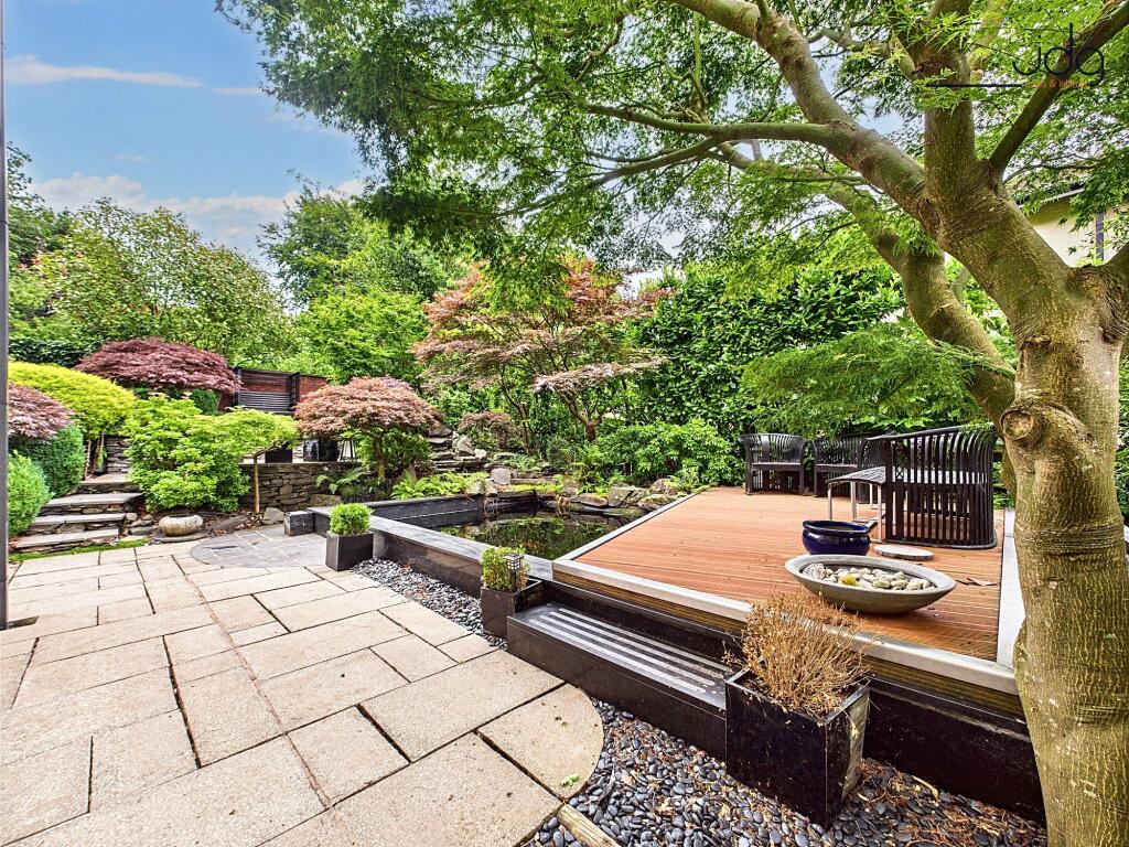 Coy fish pond and seating area with green views