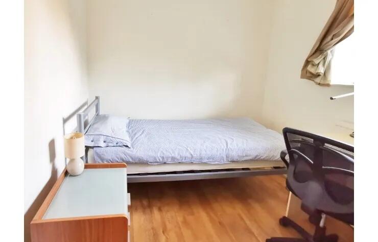 A neat single bedroom featuring a comfortable b...