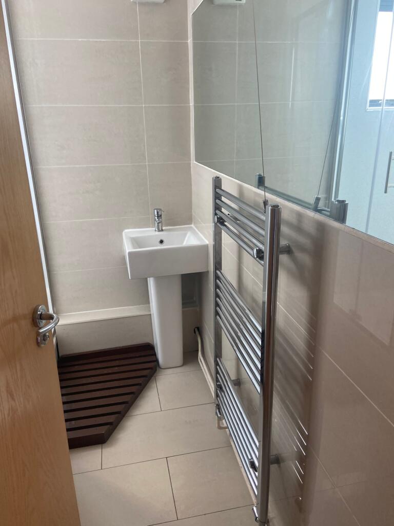 A modern and clean bathroom featuring sleek fix...