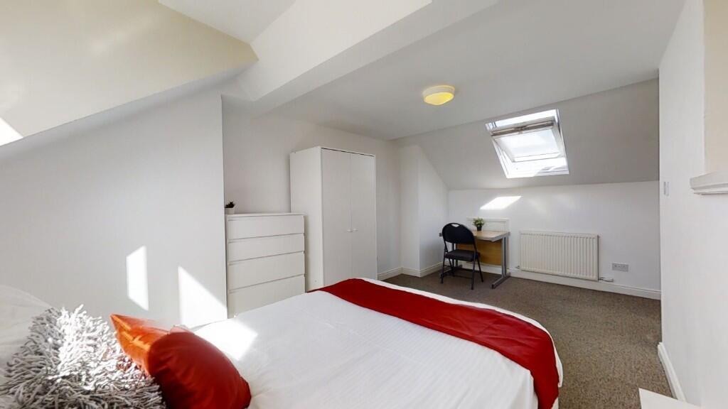Bright and cozy double bedroom featuring a comf...
