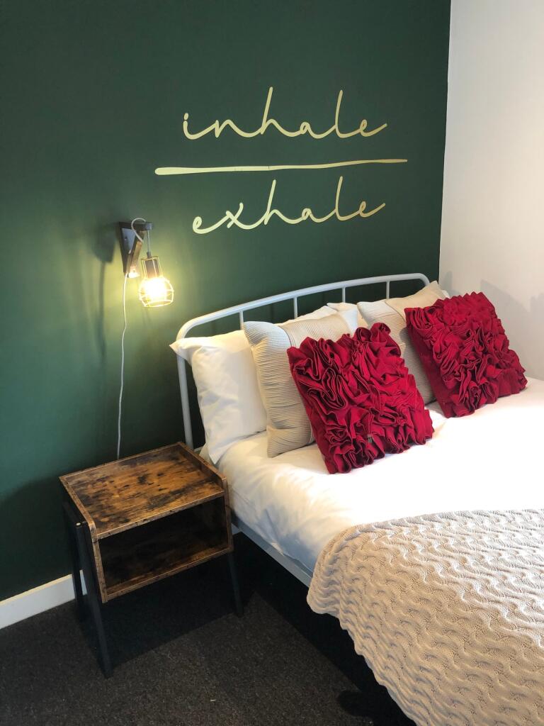 A charming double bedroom featuring a cozy atmo...