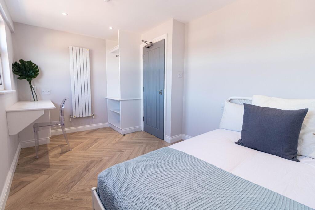 Bright and modern living room featuring a large...