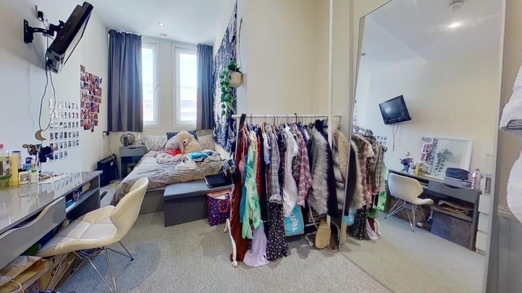 Compact and tidy space featuring a clean toilet...