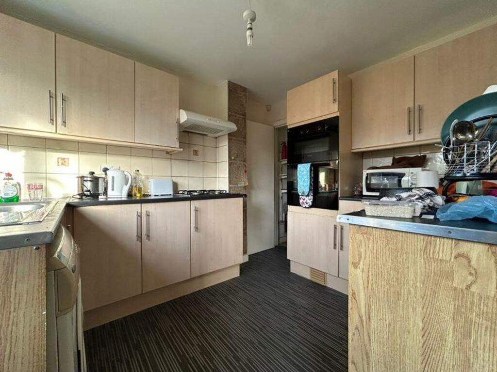 A spacious and inviting kitchenette with modern...