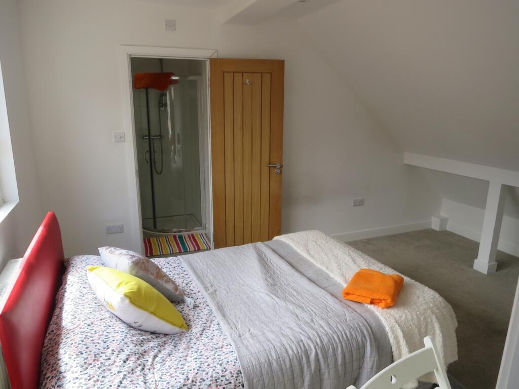 A bright and inviting double bedroom featuring ...