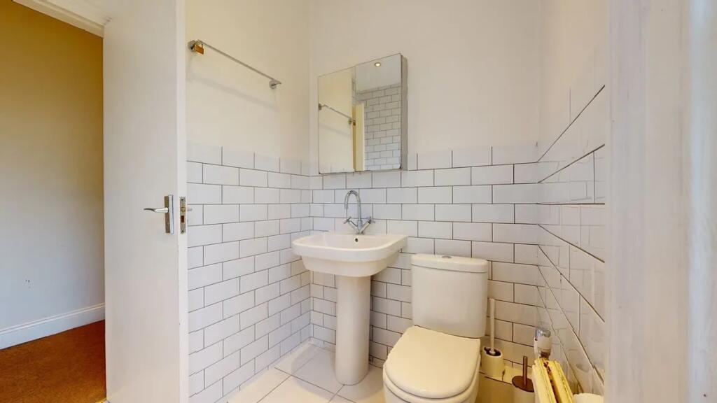 Bright and clean bathroom featuring modern whit...