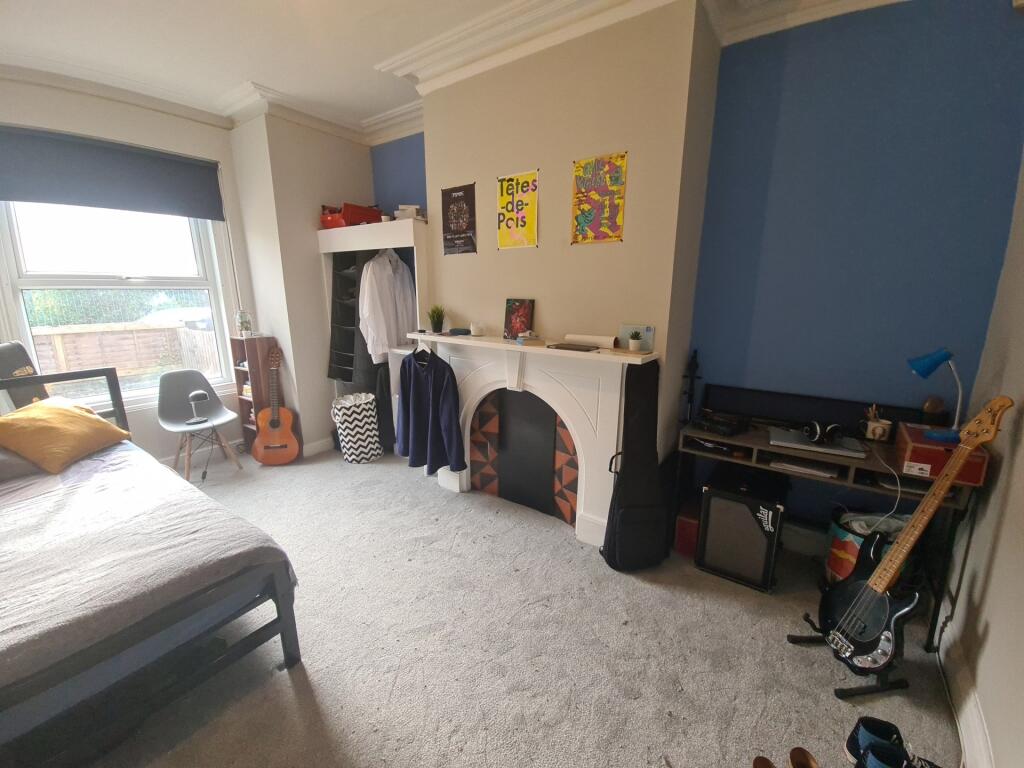 A spacious and inviting master bedroom featurin...