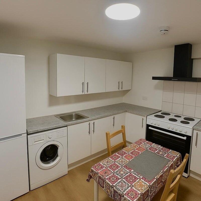 Bright and tidy kitchen featuring modern white ...
