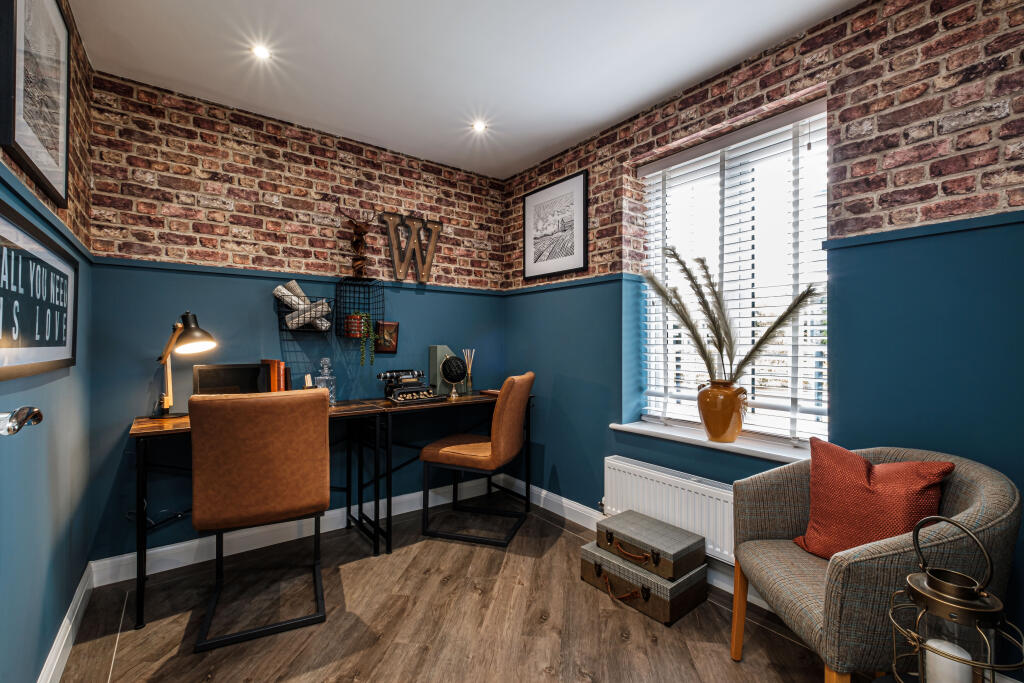 Study with brick patterned wallpaper above blue paint