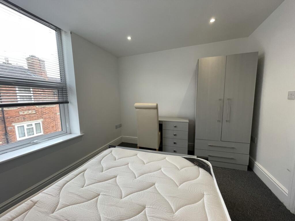 A bright and spacious double bedroom featuring ...