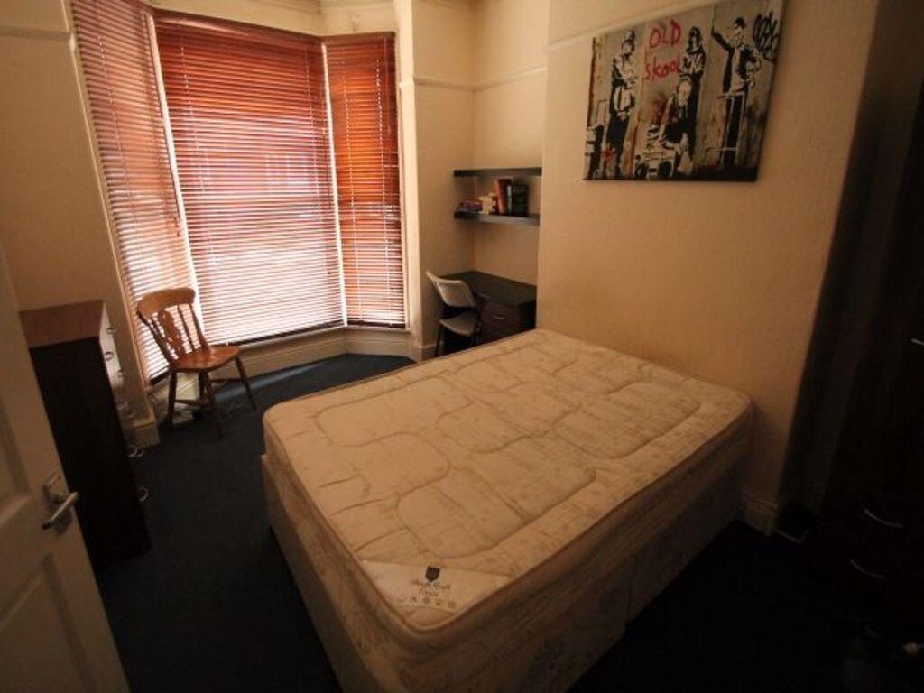 Cozy single bedroom featuring a comfortable bed...