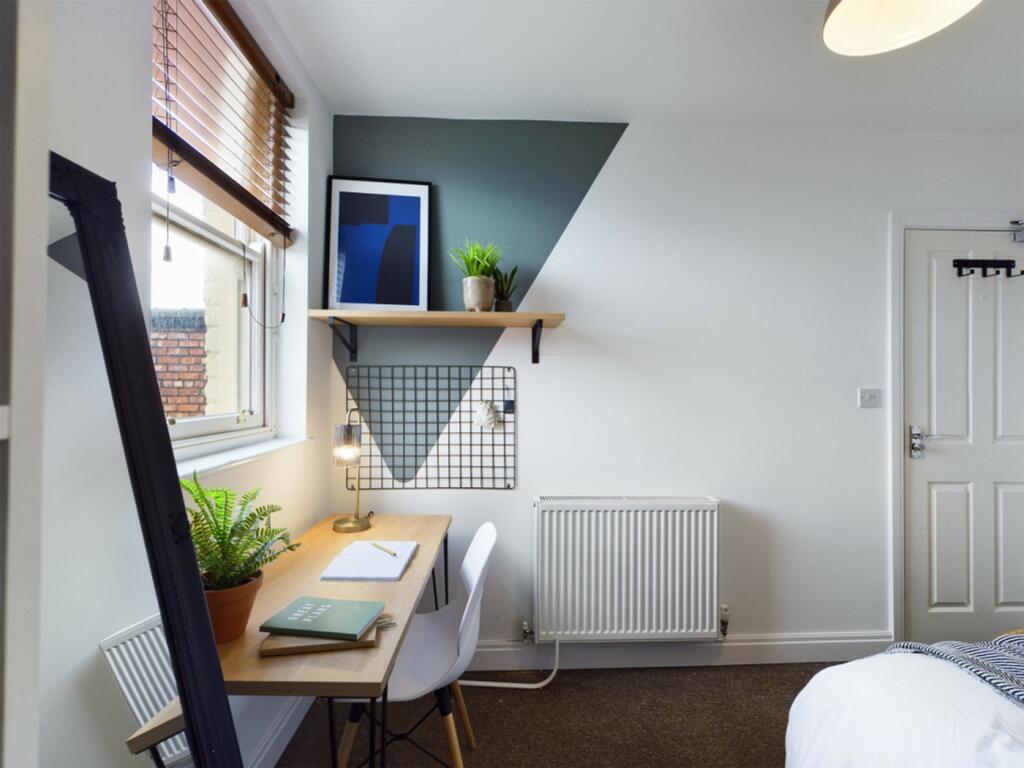 A bright and inviting double bedroom featuring ...