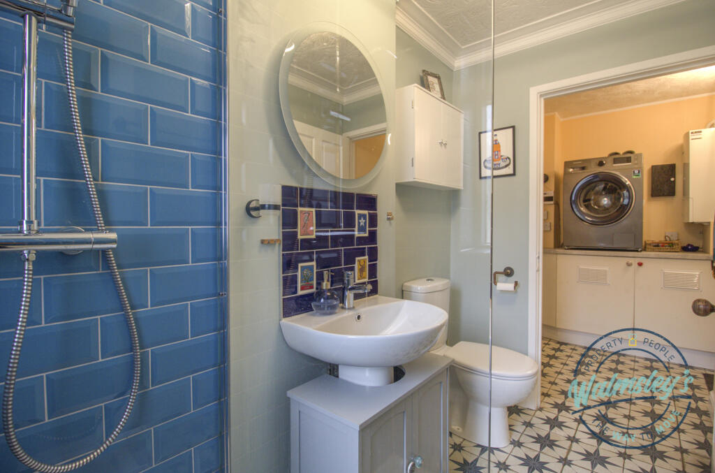 Ground floor shower room towards rear lobby utilit