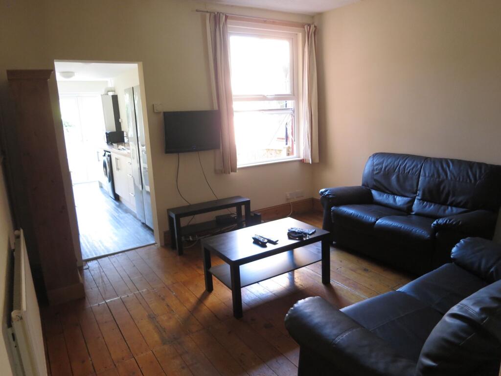 Cozy living room featuring comfortable dark lea...