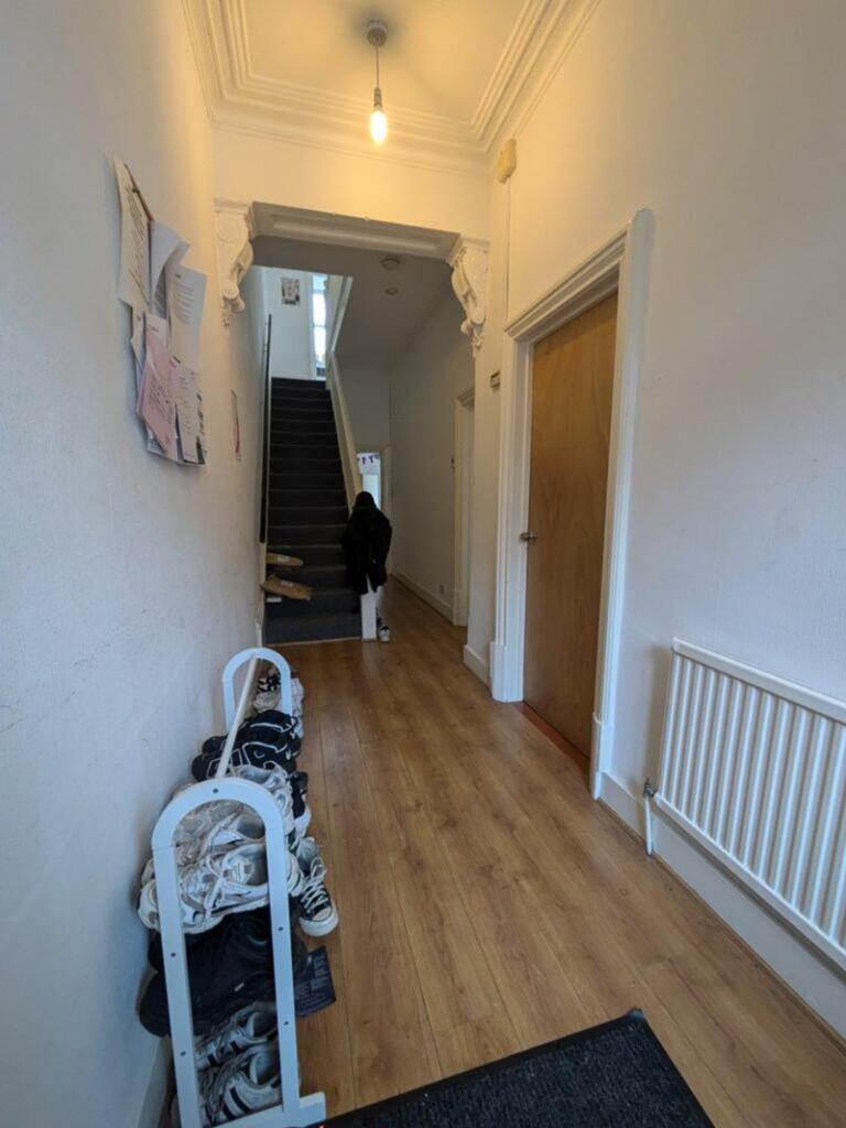 A spacious and inviting hallway with natural li...