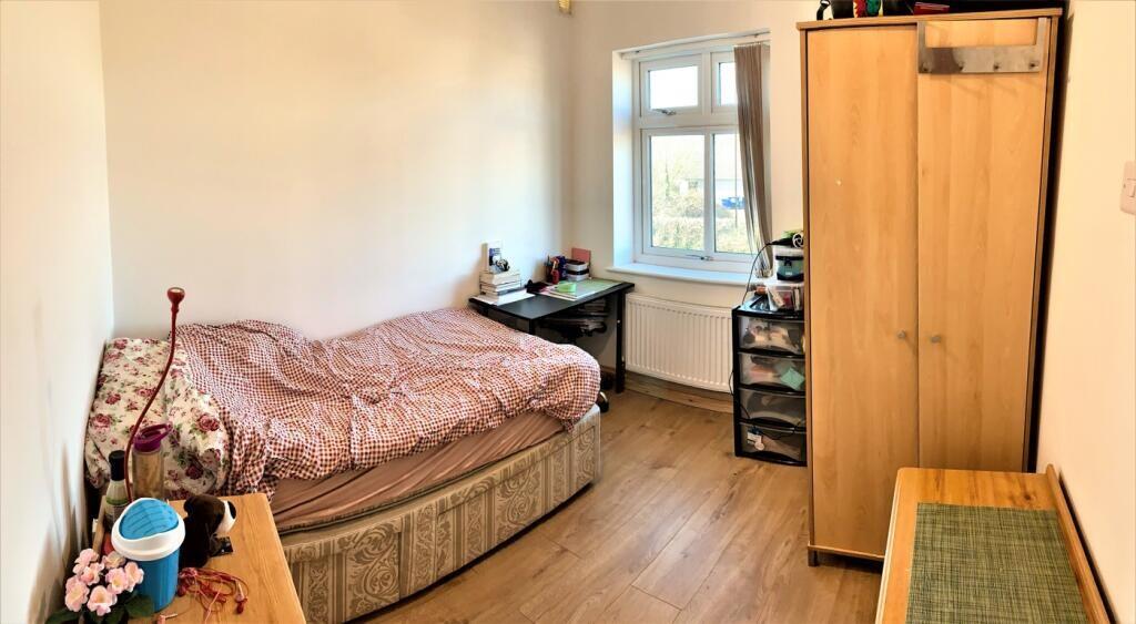 Cozy double bedroom featuring a comfortable bed...