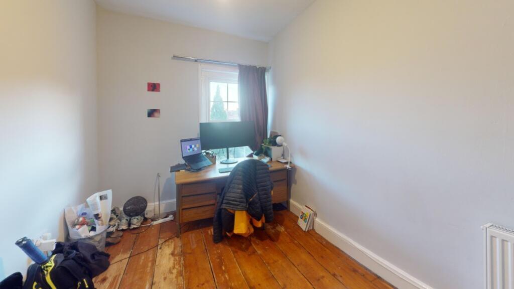 A cozy double bedroom with ample natural light ...