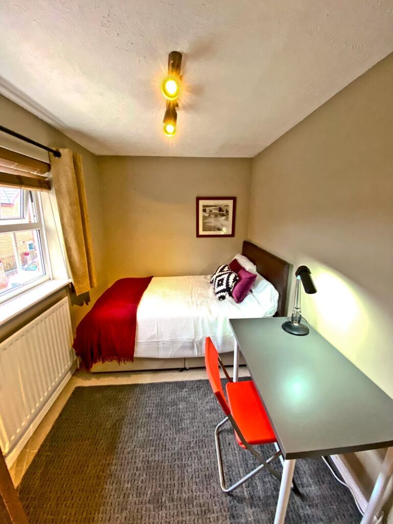 This inviting double bedroom features a cozy la...