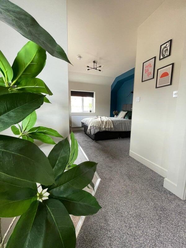 A bright and inviting master bedroom featuring ...