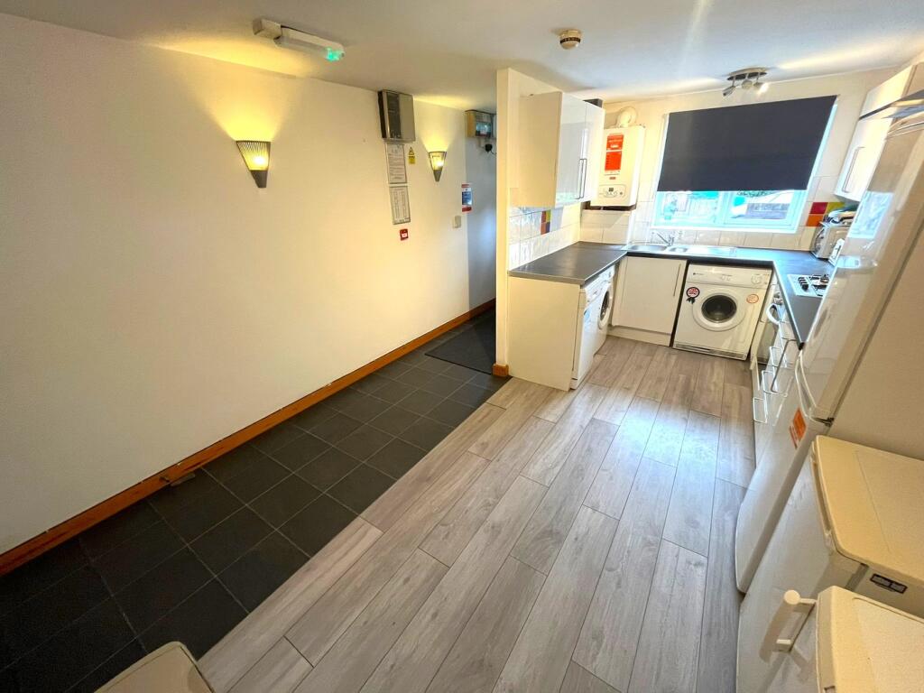 A spacious and modern kitchenette equipped with...