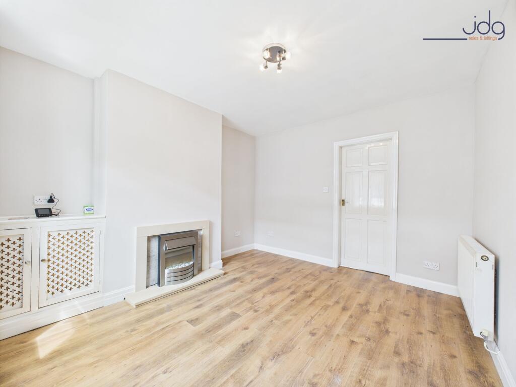 Lounge with wood-effect flooring and electric fire