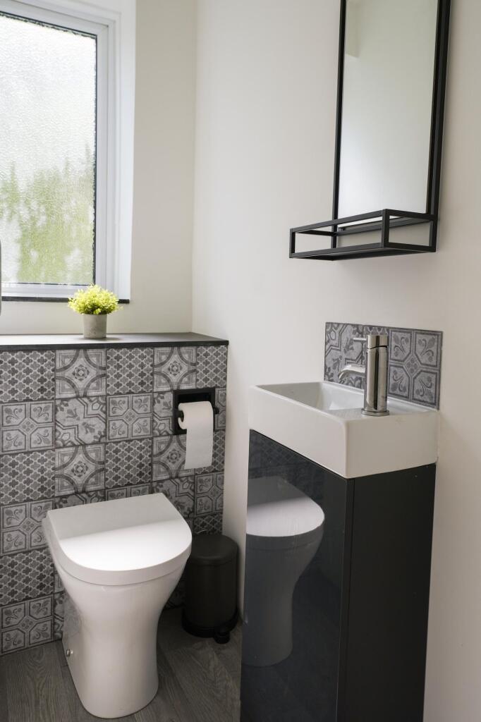 Bright and modern single toilet featuring styli...