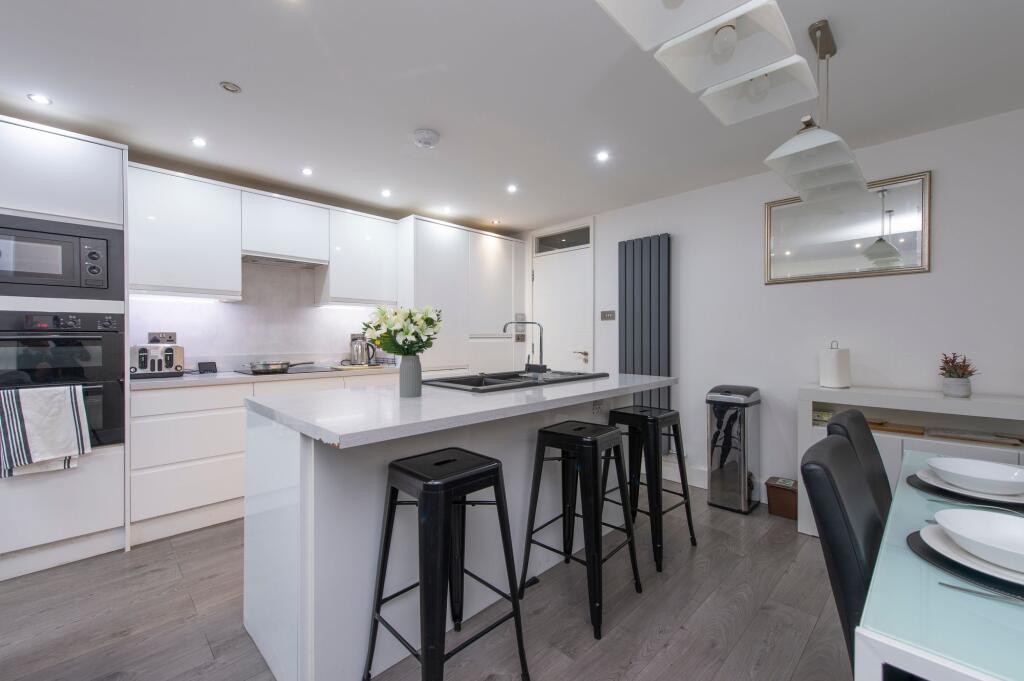 A modern, well-maintained kitchen with sleek wh...