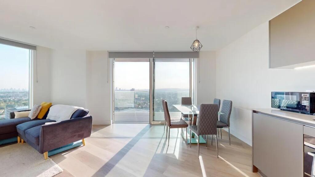 Bright and modern living room featuring a styli...