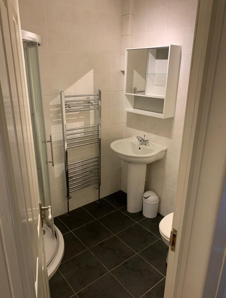 A modern and tidy bathroom featuring a spacious...