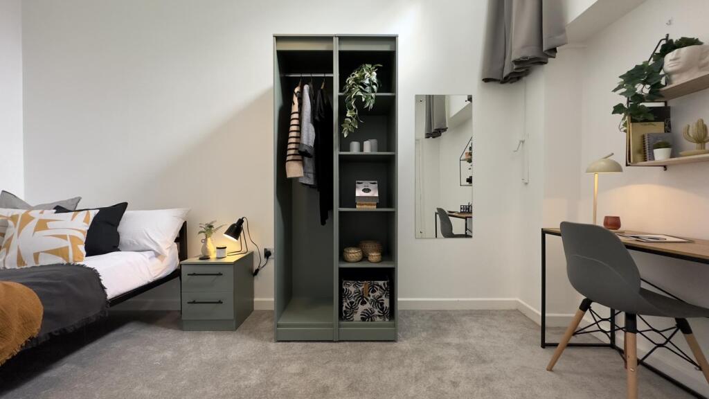 A stylish double bedroom featuring a well-organ...