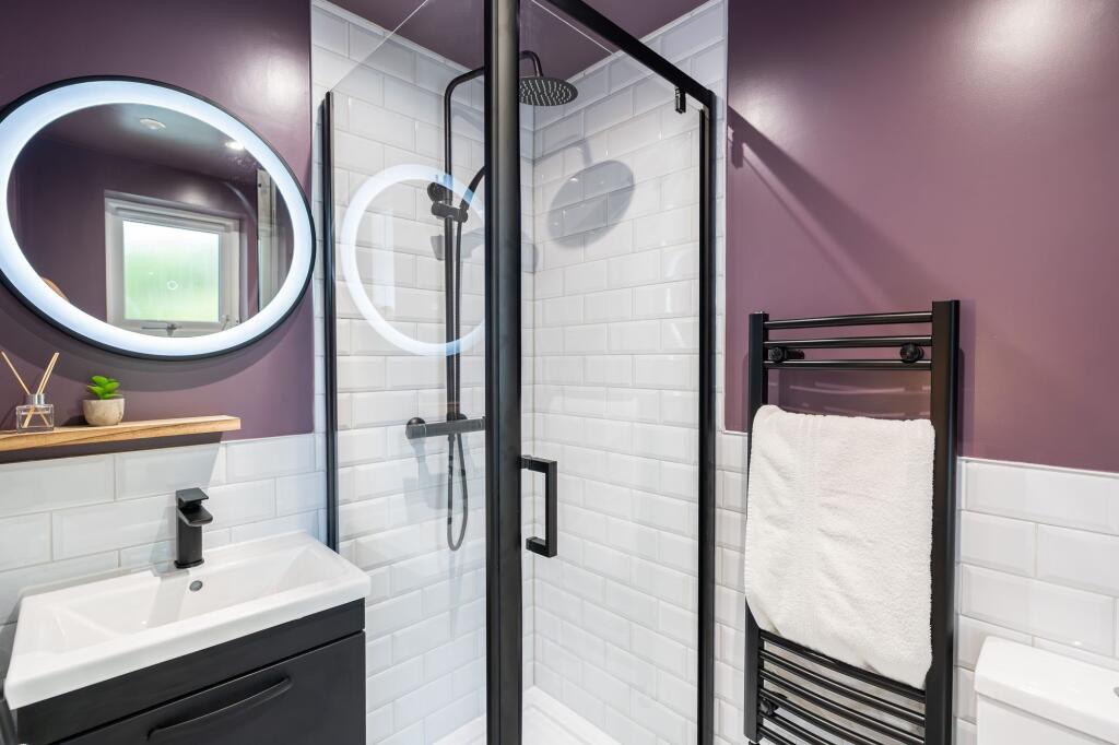 Modern bathroom featuring a sleek shower enclos...