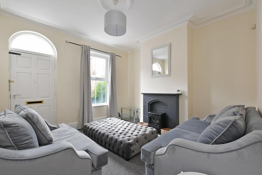 A bright and cozy living room featuring two com...