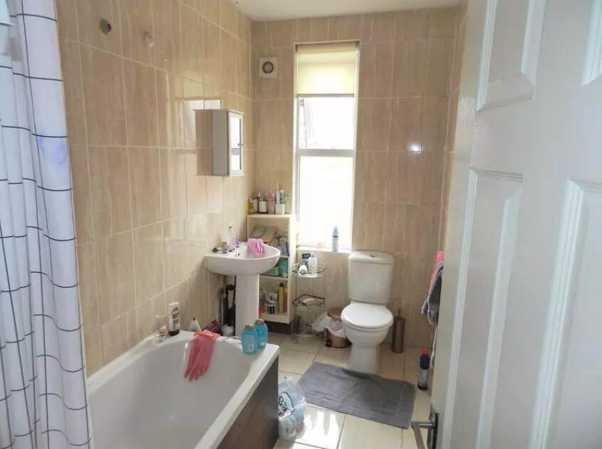 A bright and clean bathroom featuring a full ba...