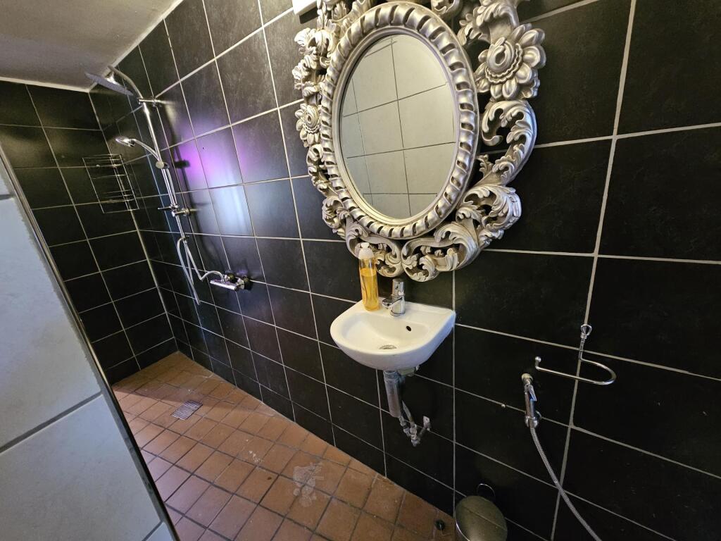 A clean, well-maintained bathroom featuring a d...