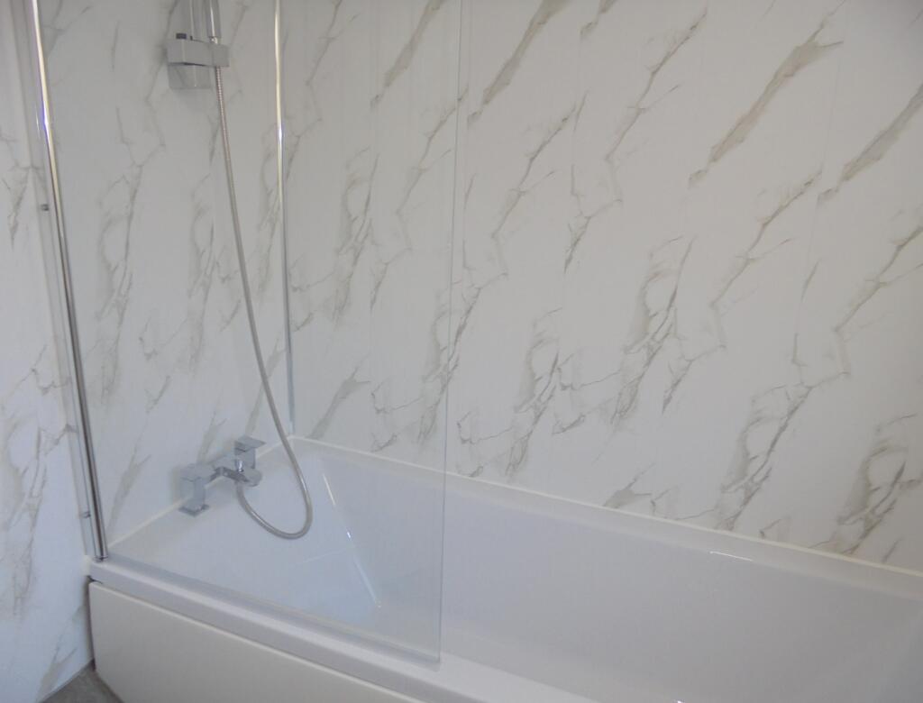 A spacious and clean bathroom featuring a moder...