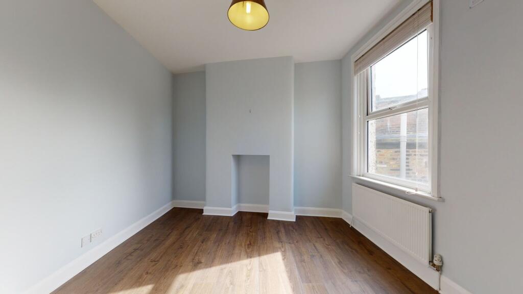 A bright and freshly painted single bedroom fea...