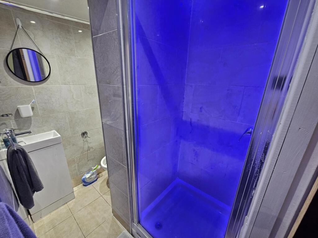 Modern bathroom featuring a spacious shower enc...