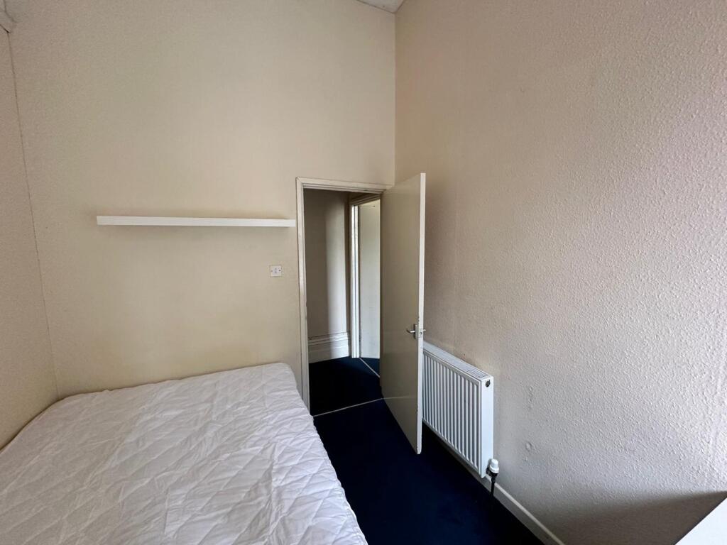 A cozy and tidy double bedroom with a welcoming...