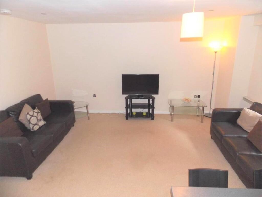 A comfortable living room featuring two dark so...