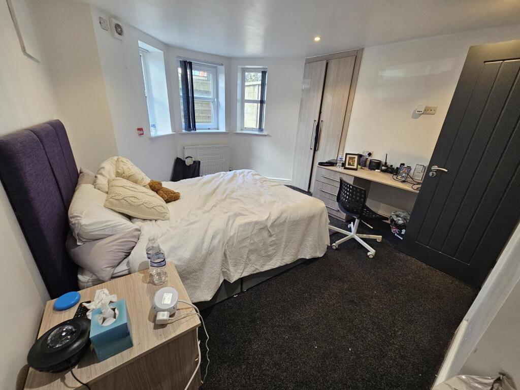 A cozy and well-maintained bedroom featuring a ...