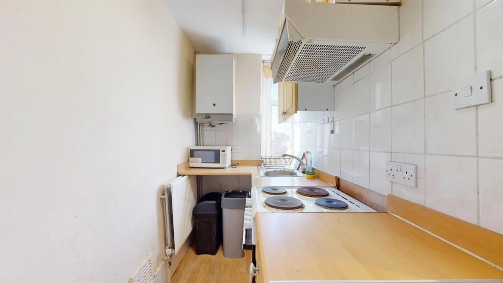 A compact kitchen featuring essential appliance...