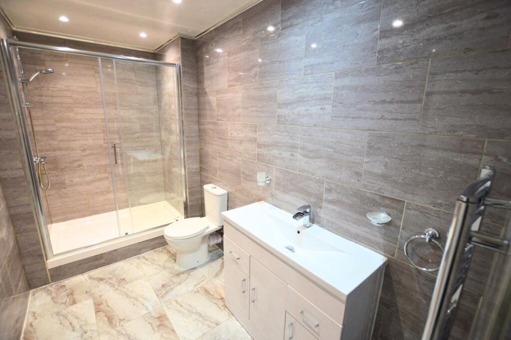 Bright and modern bathroom suite featuring a sp...