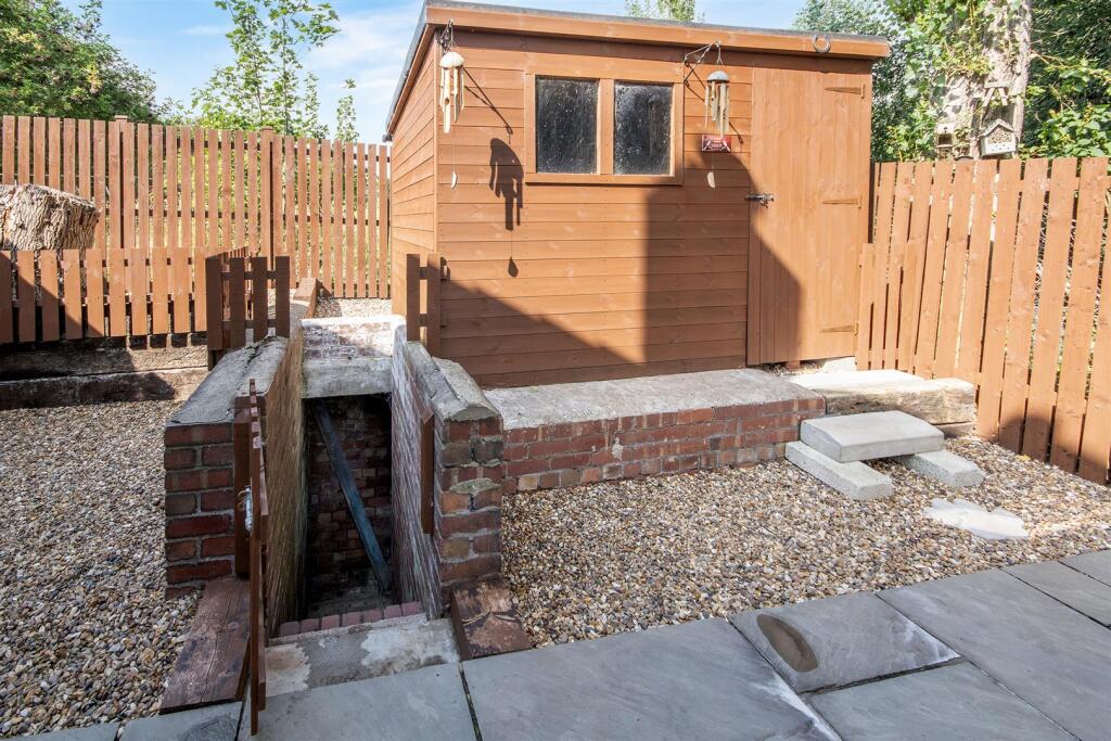 Side of Property and Air Raid Shelter