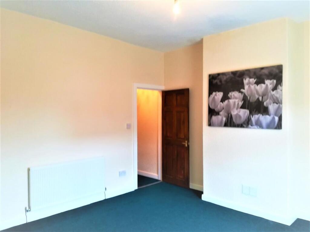 Bright, freshly painted bedroom with neutral wa...
