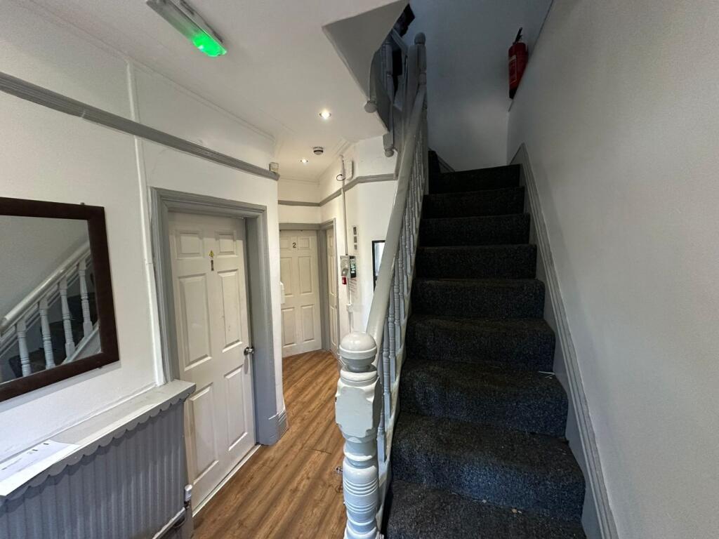 Bright, tidy entrance hallway with wood-effect ...