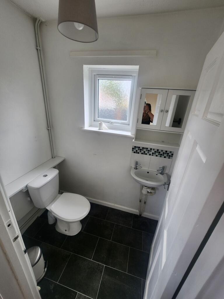 A neat and well-maintained small toilet room fe...
