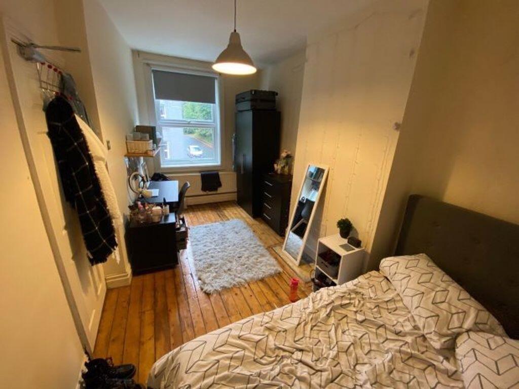 Cozy and well-kept bedroom featuring a comforta...