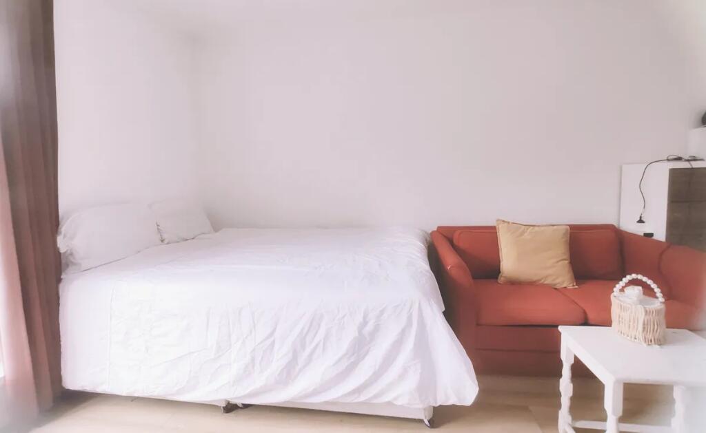 A bright and neatly arranged double bedroom fea...