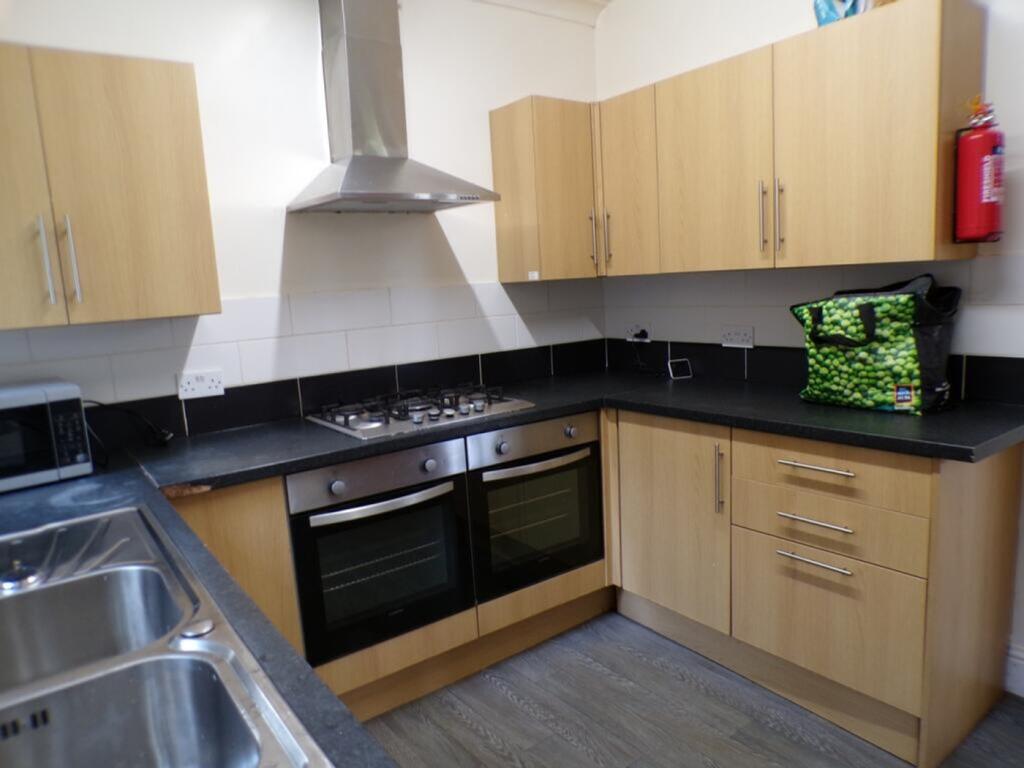 Modern kitchen featuring stylish wooden cabinet...